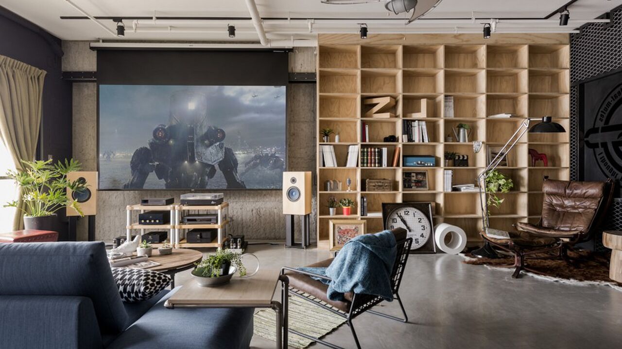 Illustratie voor: Het industriële design, moderne meubels, accessoires én een beamer als tv maken het helemaal compleet