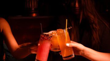 Mensen die proosten bij een cocktailbar in Amsterdam